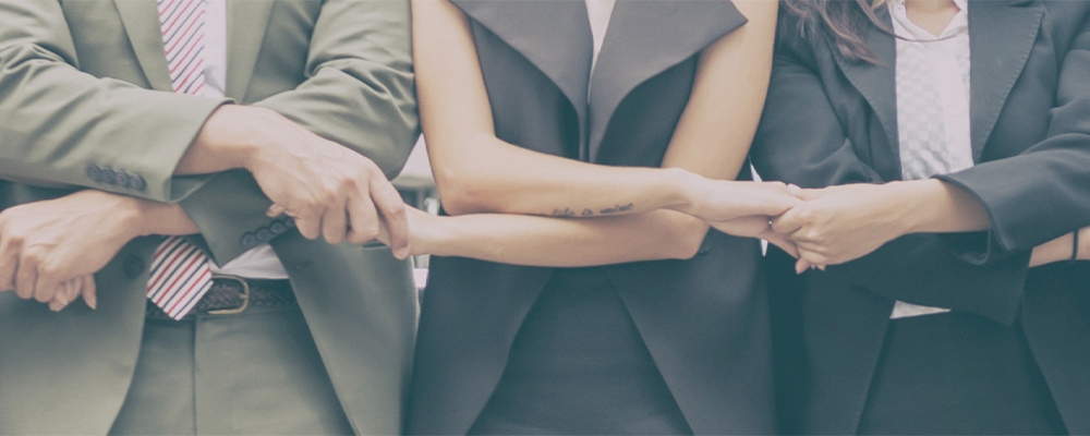 Group of people interlocking arms