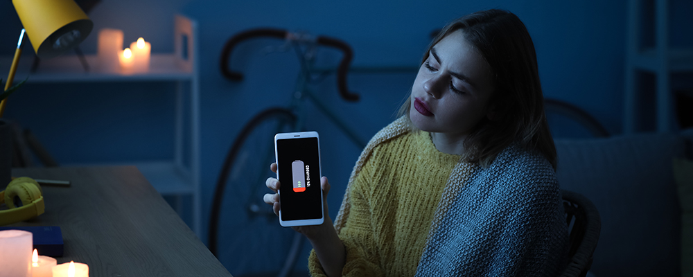 Women holding phone disappointed with phone battery