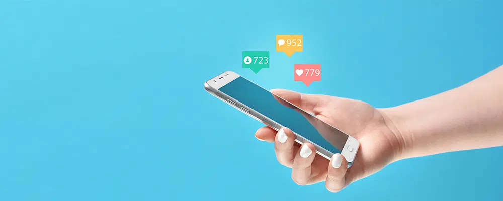 Hand holding phone with notifications going off