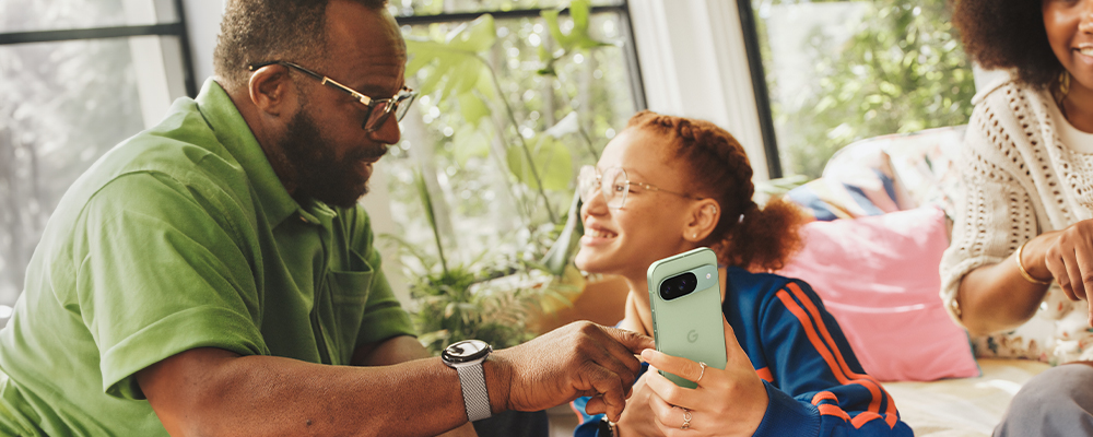 Father and Daughter spending time together looking at the Pixel 9