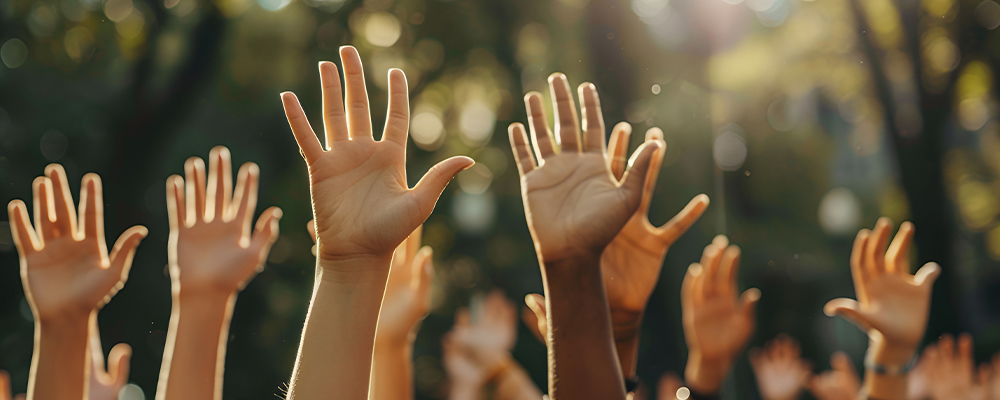 Group of people holding up there hands together