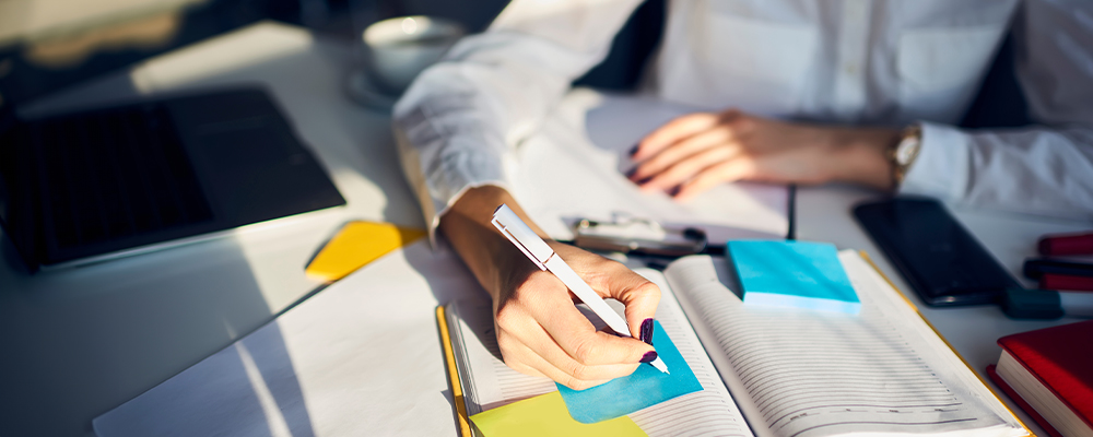 Someone taking notes from a book