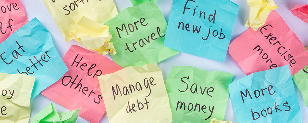 New year goals or resolutions on bright colorful paper stickers. New Year goals List 2023, plan listing of new year beginnings goals and resolutions setting. Flat lay copy space on blue background