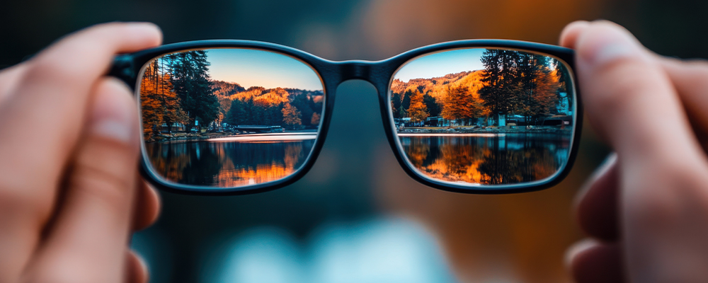 Glassing being held up to a landscape showing that it can be seen clearly through them